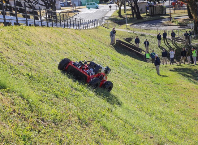 A salesman demonstrates a Sanyokiki remote-controlled lawn mower to employees of the Directorate of Public Works at Camp Zama, Japan, Dec. 6, 2024. DPW crews plan to use the mower to cut grass on the facility's steep hills.