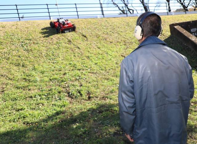 A salesman demonstrates a Sanyokiki remote-controlled lawn mower to employees of the Directorate of Public Works at Camp Zama, Japan, Dec. 6, 2024. DPW crews plan to use the mower to cut grass on the facility's steep hills.