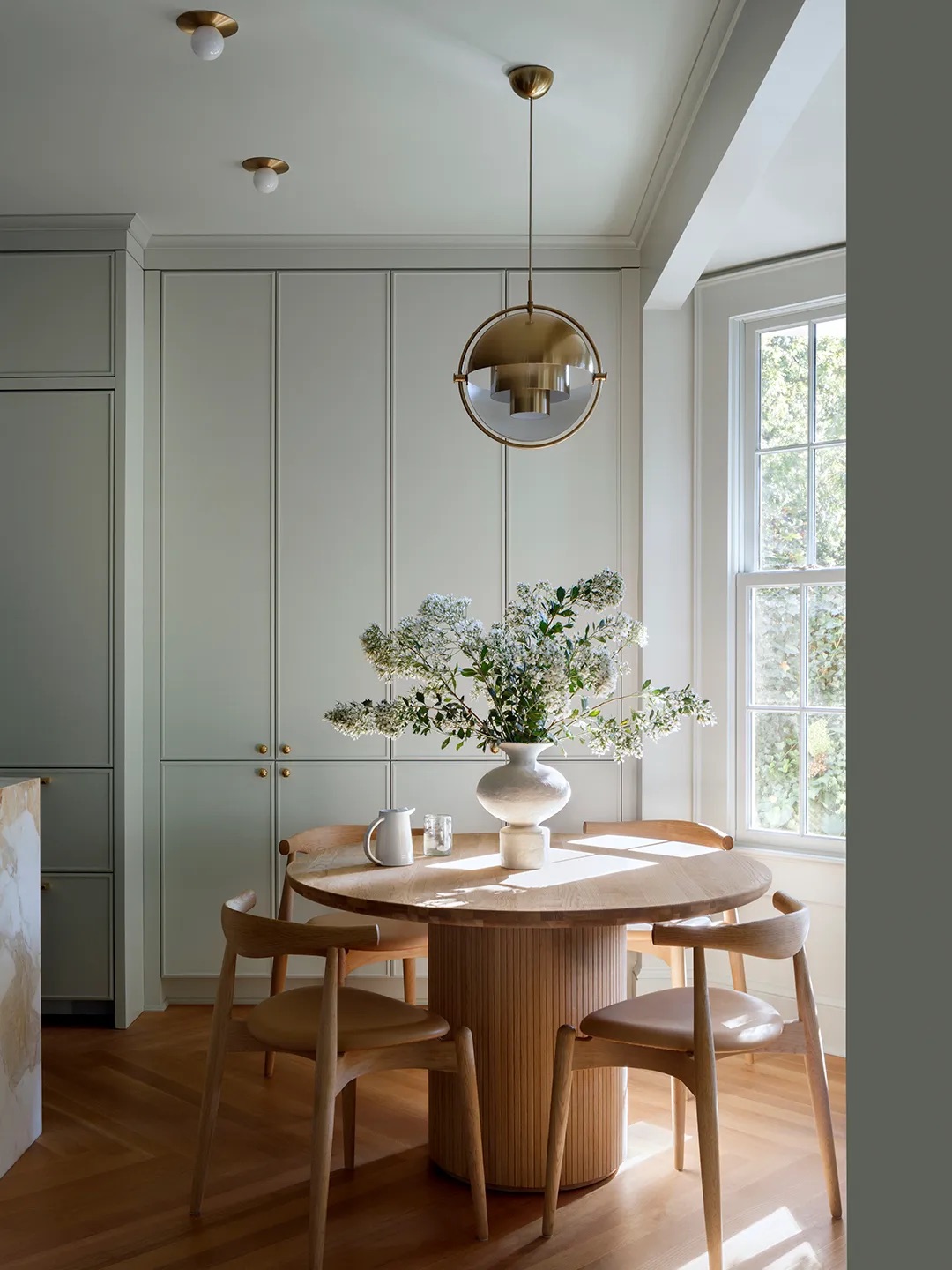 Dining table near pantry cupboards