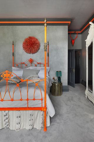 Bedroom with neon colored bed and neon accents on the gray walls