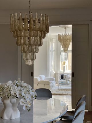 Hang Murano chandeliers in a dining room and living room