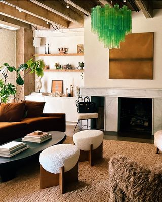 a neutral living room with a light green Murano glass chandelier