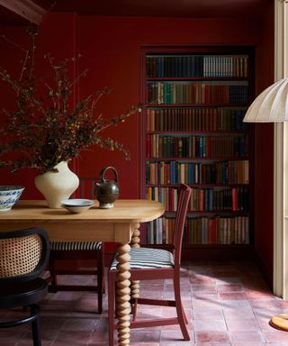 Dining room painted cherry red with pink tiled floor