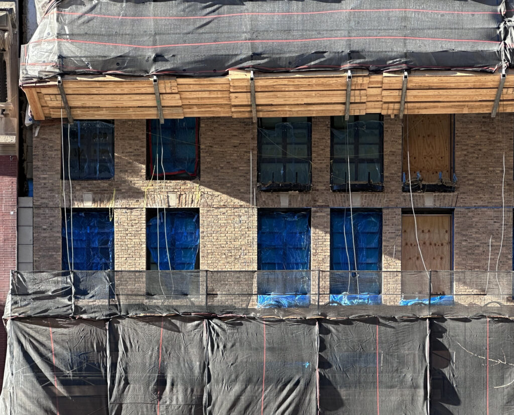 Facade installation underway at 16 Fifth Avenue in Greenwich Village, Manhattan