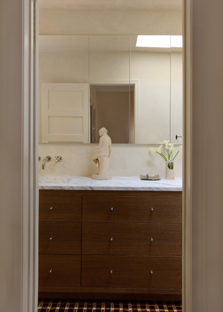 Warm wooden drawers with white worktop and faucet