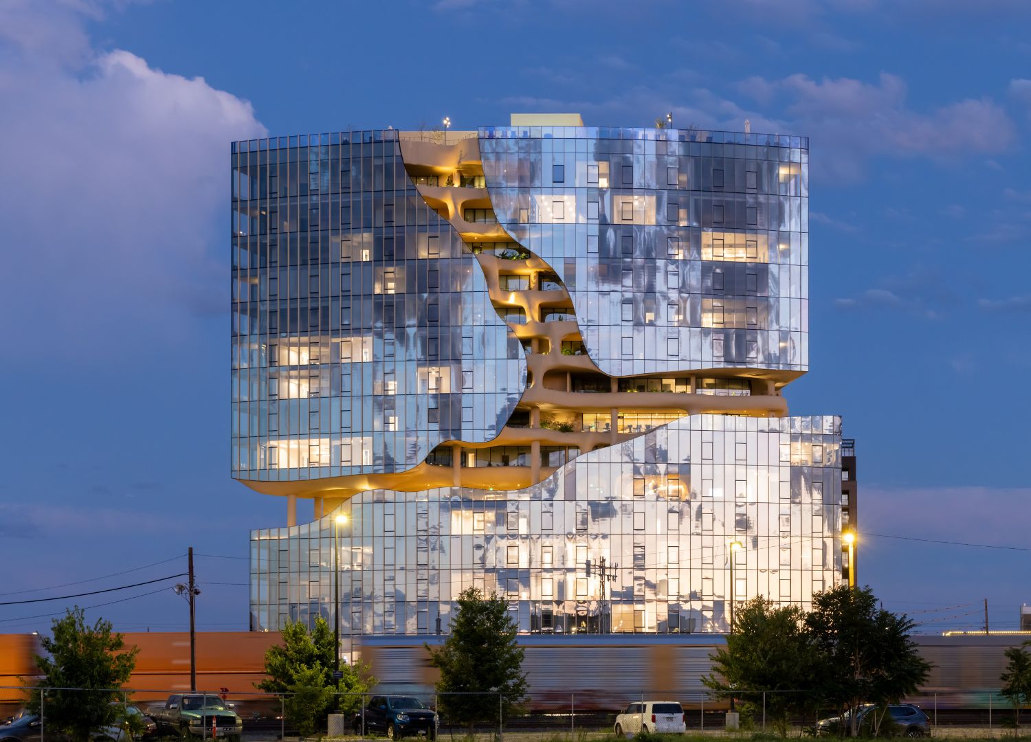 The building introduces a new, immersive living experience that emphasizes and simultaneously strengthens its residents' connection to nature. - © MAD Architects