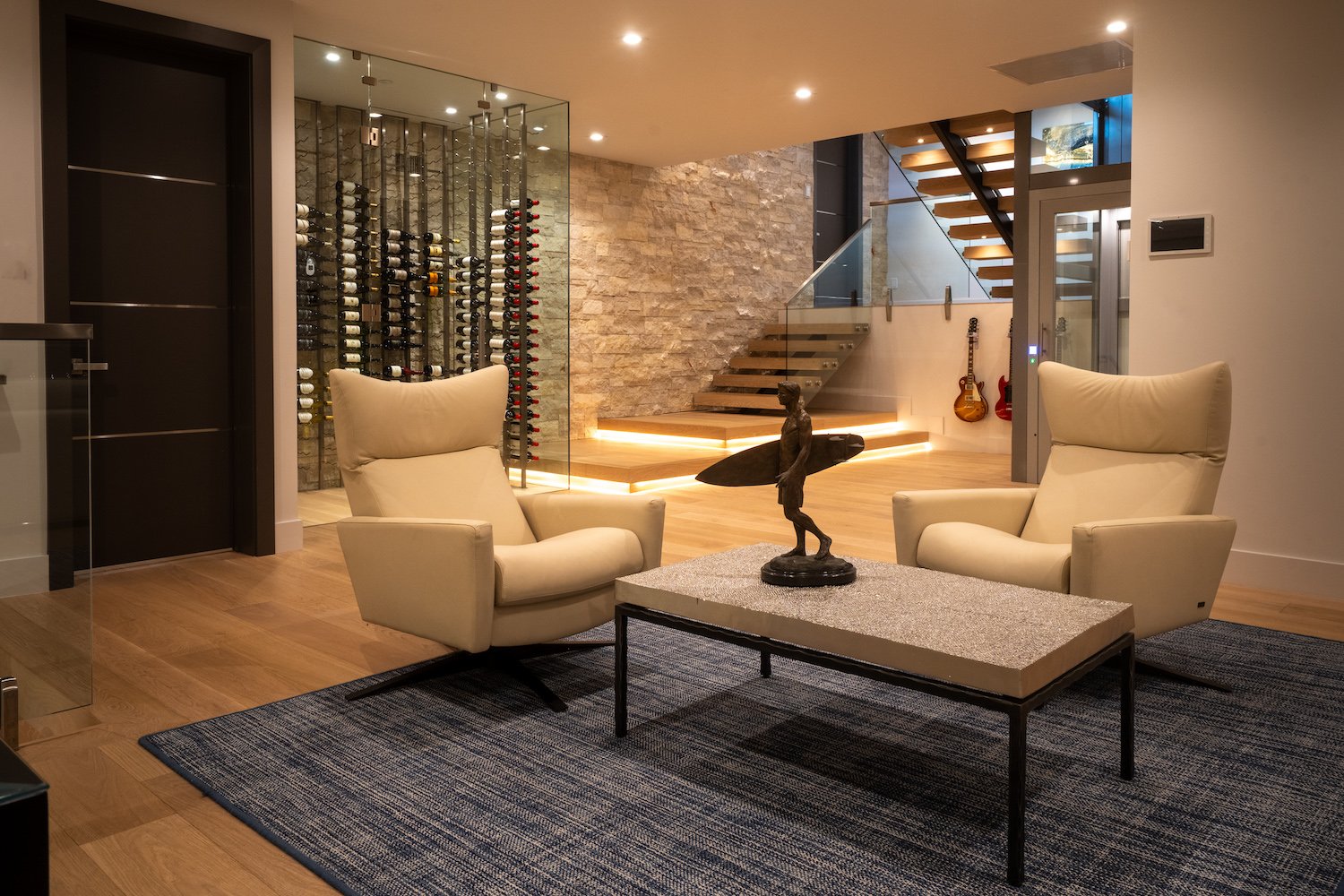 Interior of the luxury San Diego home in Del Mar owned by Kerry and Corrine Marsh, featuring a wine cellar, guitars and a surfer statue