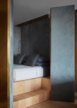 Dark black bedroom corner with wooden steps