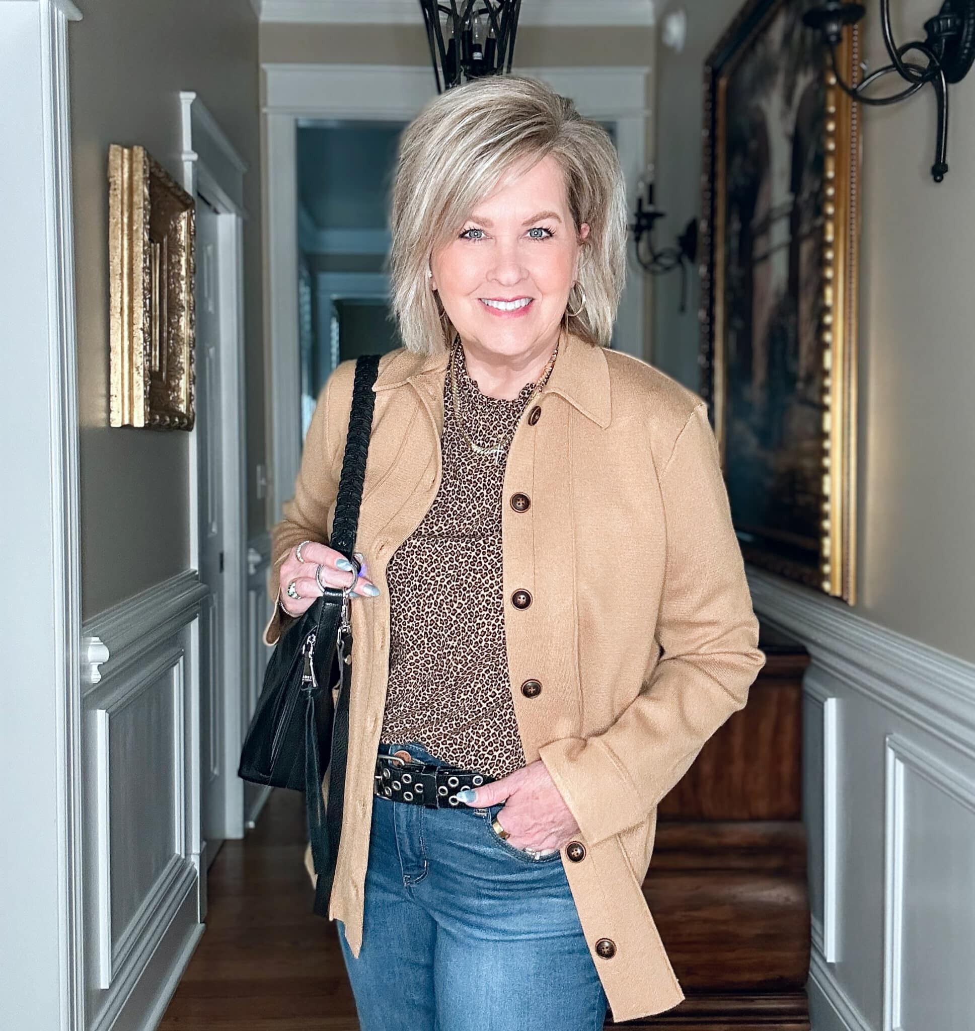 Tania Stephens wears a leopard print top, camel knit blazer and jeans