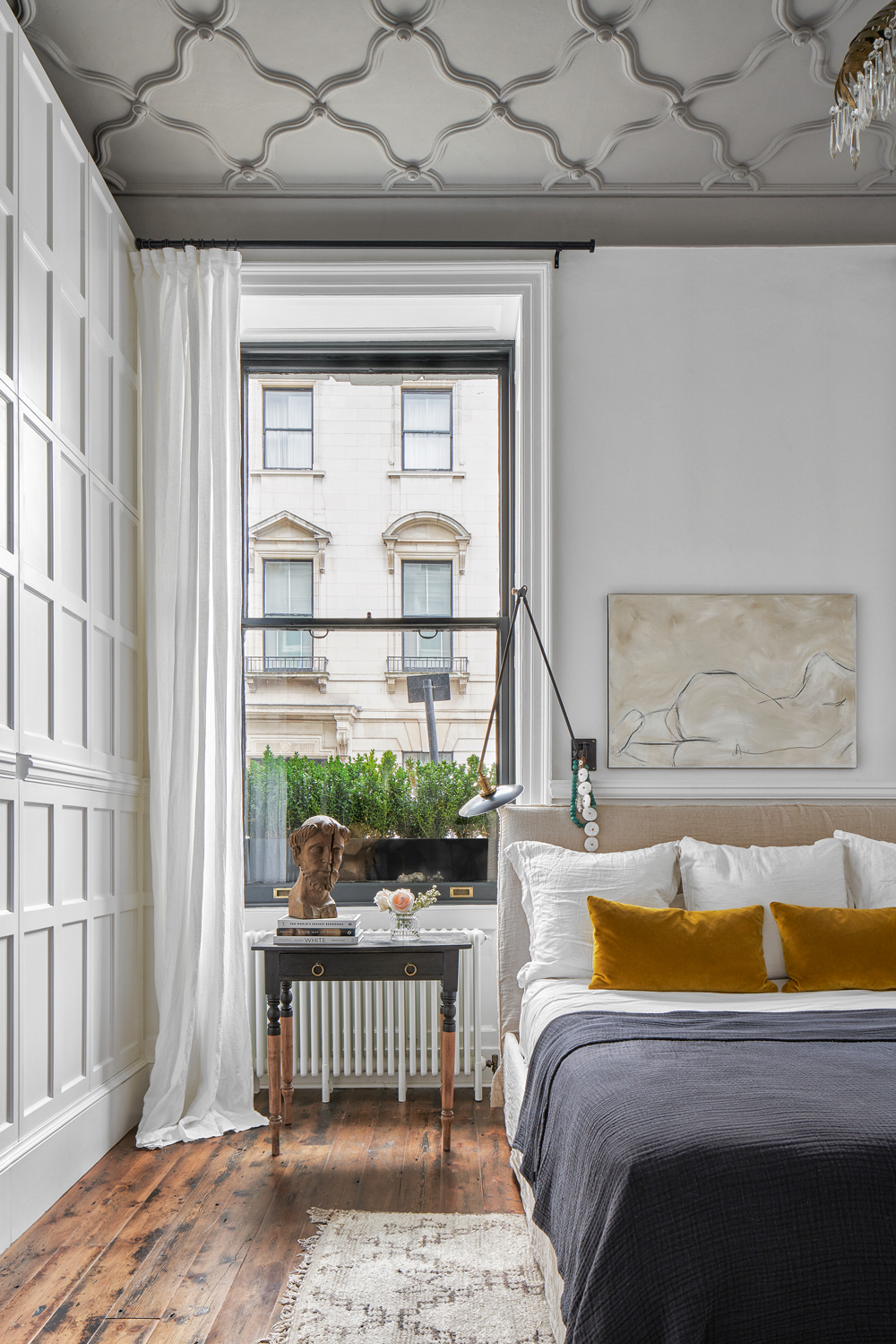 Master bedroom with gray painted ceiling and paneled walls