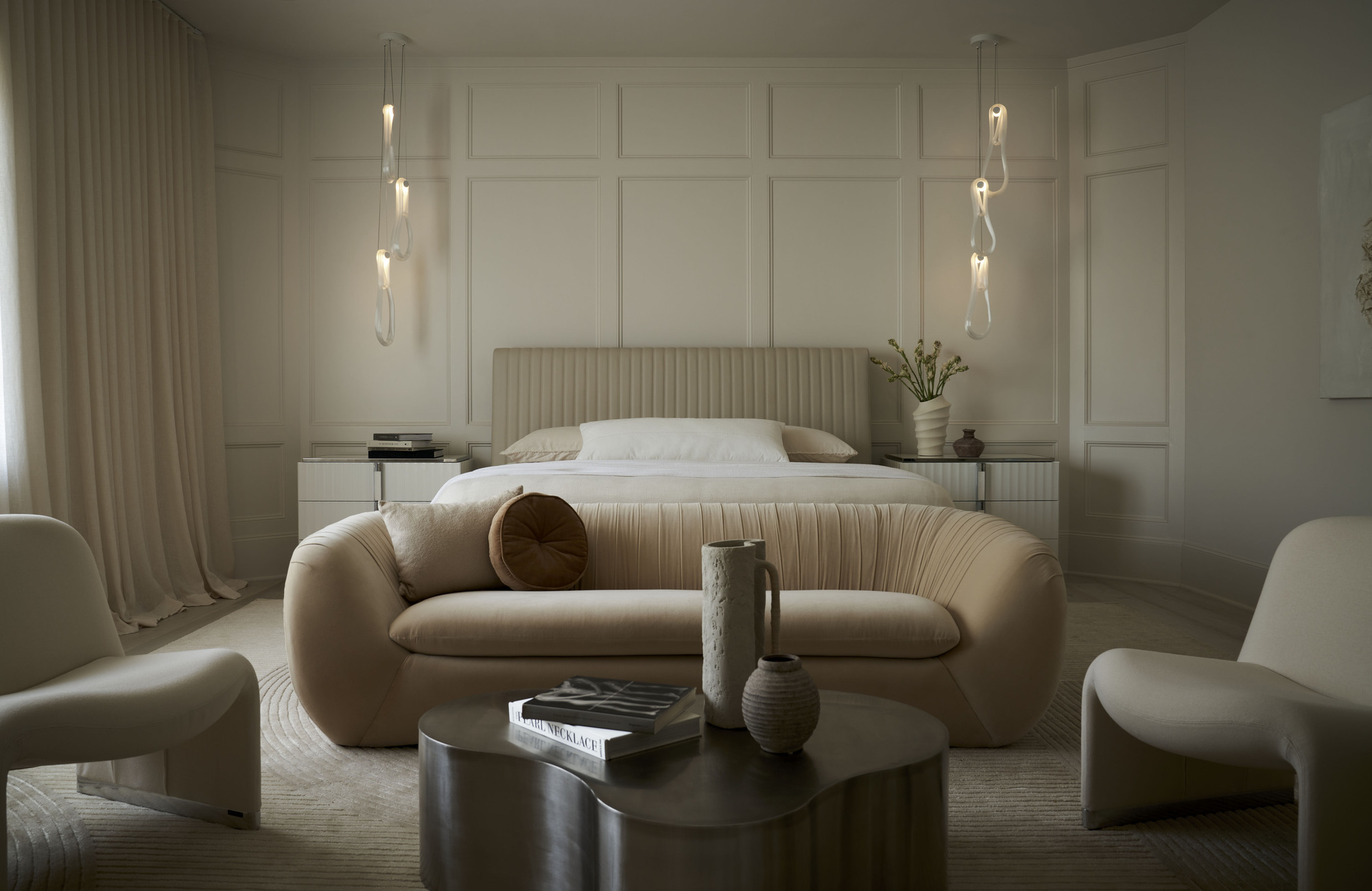 Neutral master bedroom with seating