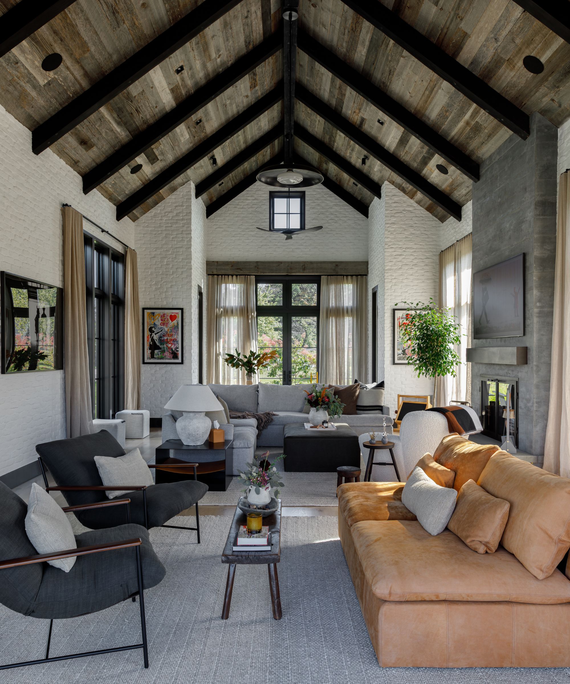 An organic, modern living room with a sloping wooden ceiling