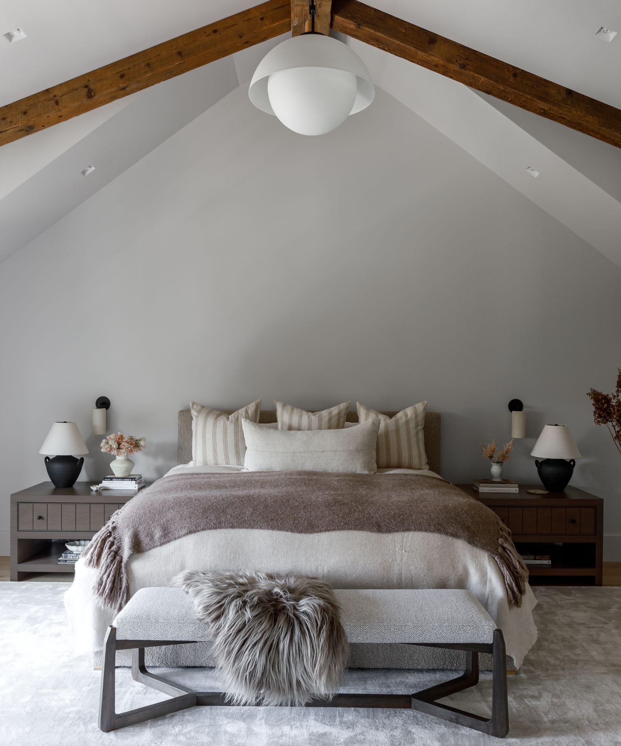 A neutral, organic, modern bedroom with layered textiles