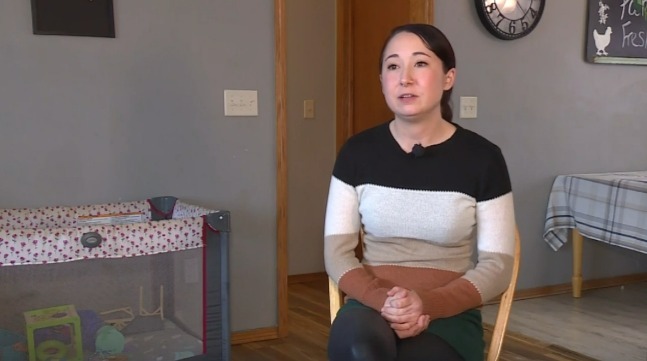 Woman sits on a chair and discusses a lawsuit over a backyard fence.