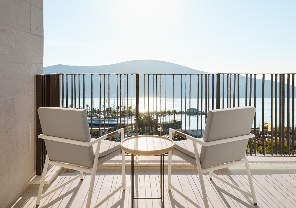 Chairs and a table on the veranda overlooking the bay at SIRO Boka Place