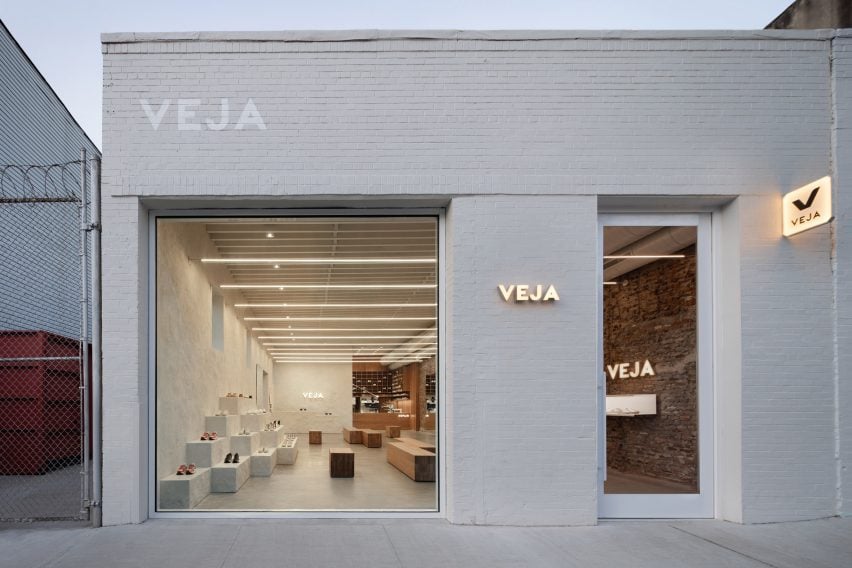 Veja Brooklyn Storefront with white masonry and large window that looks inside