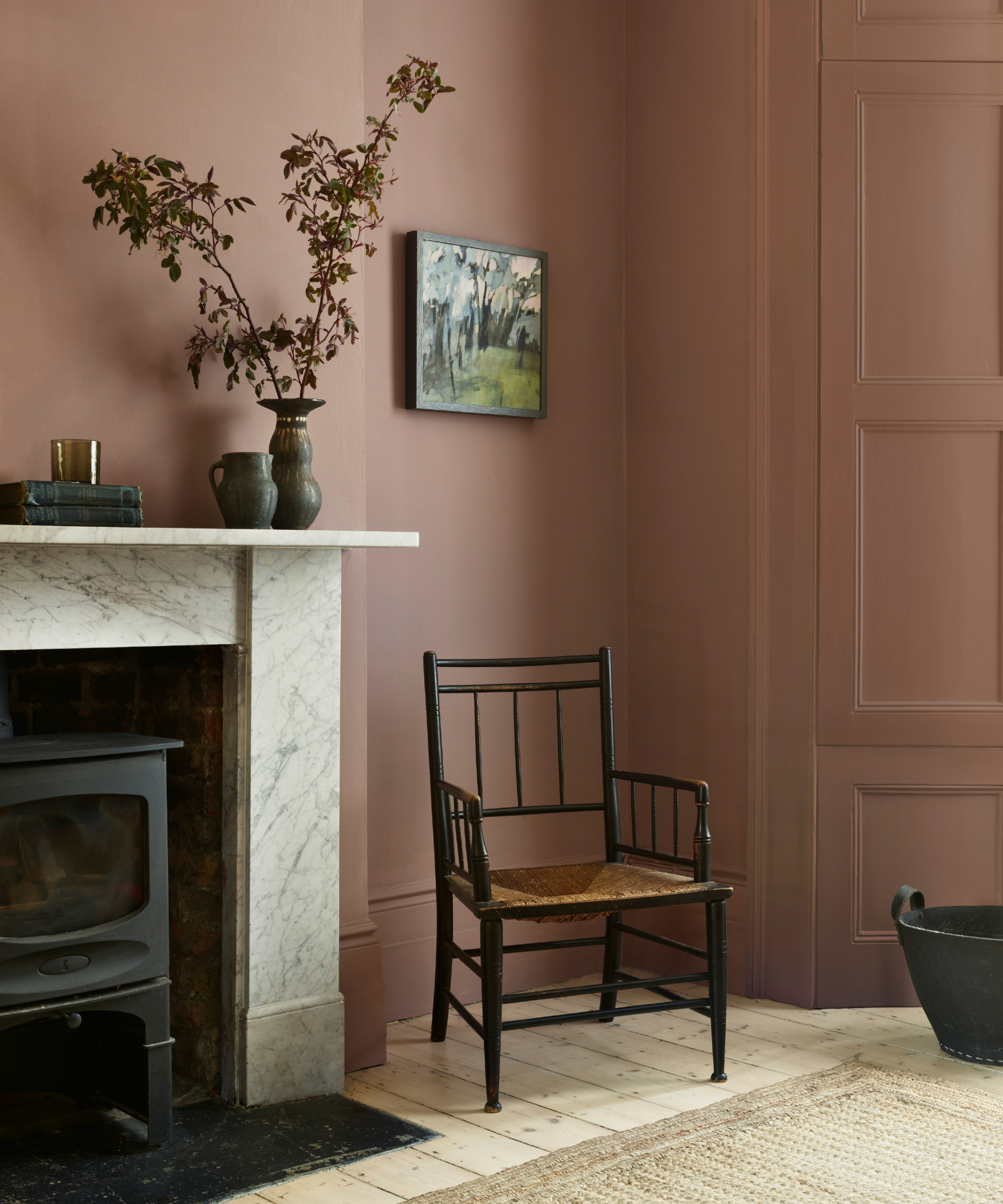 Light brown living room with marble fire, block burner, vases, artwork, black wood and cane, droson panels, carpet
