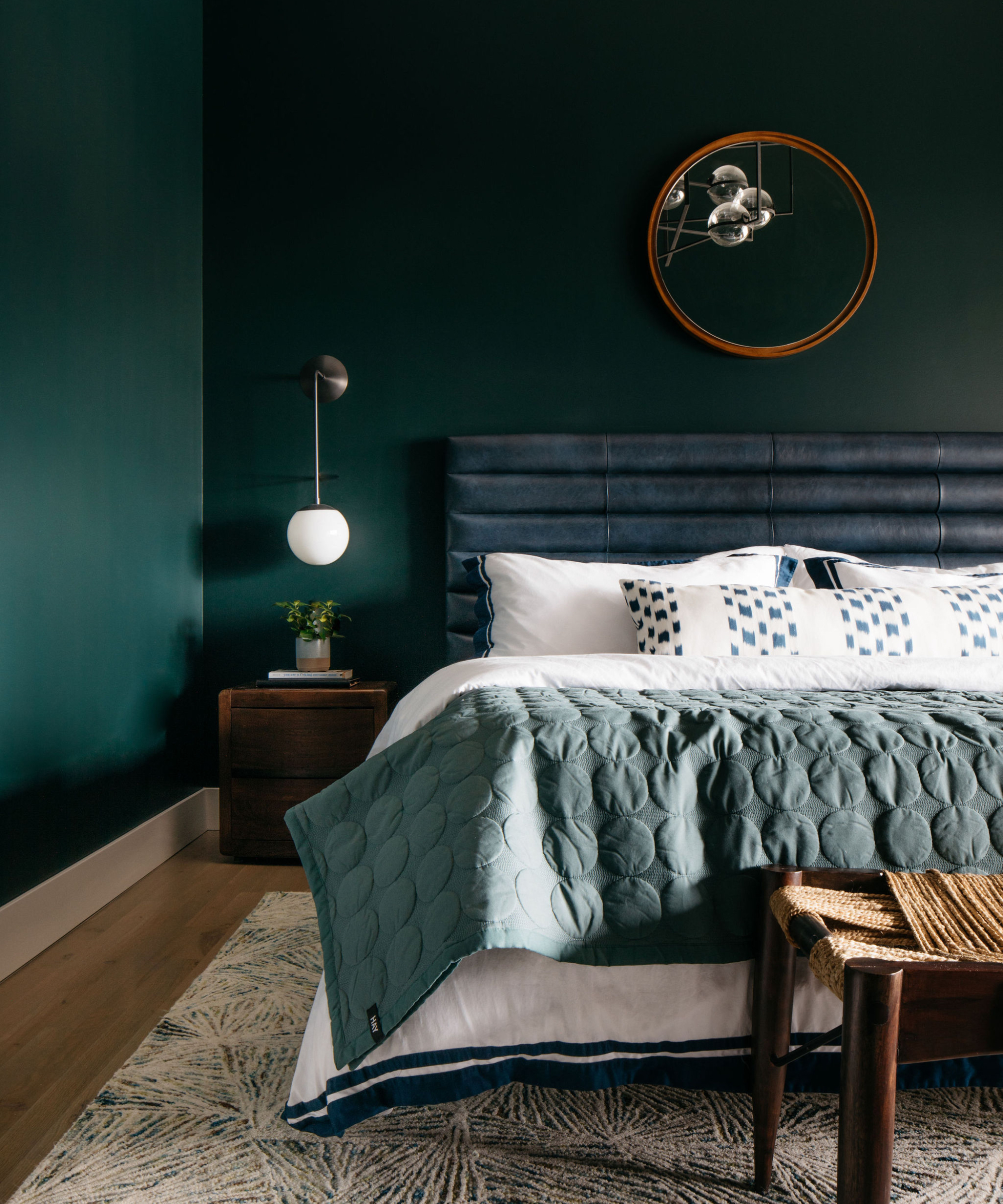 Dark green bedroom with emerald walls, hardwood floor, carpet, padded