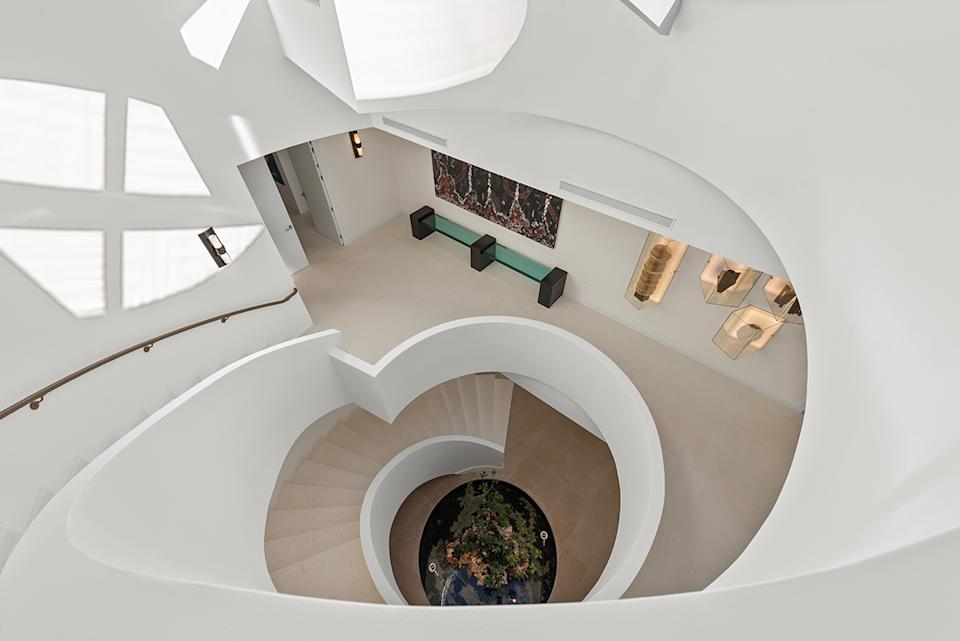 A skylight ends the house-inspired spiral staircase of the house.