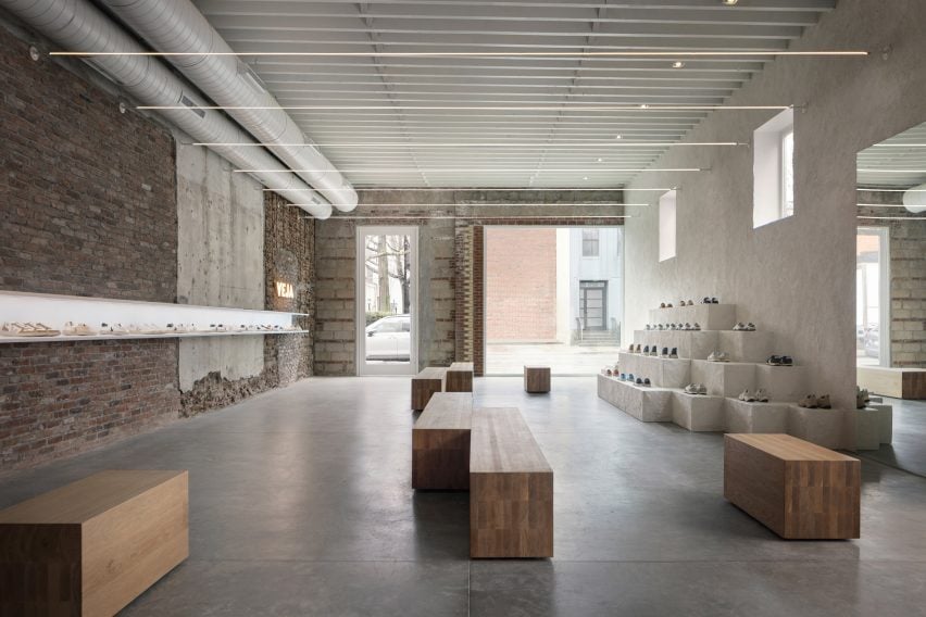 Minimalist shoe store with brick, concrete and plaster walls