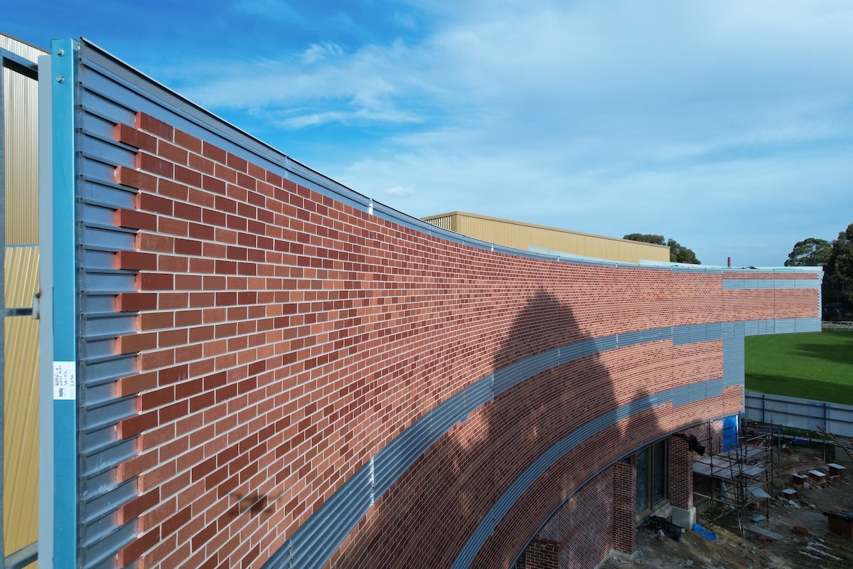 The round has an imposing, curved facade made of red brick. (Image: CMG frame)