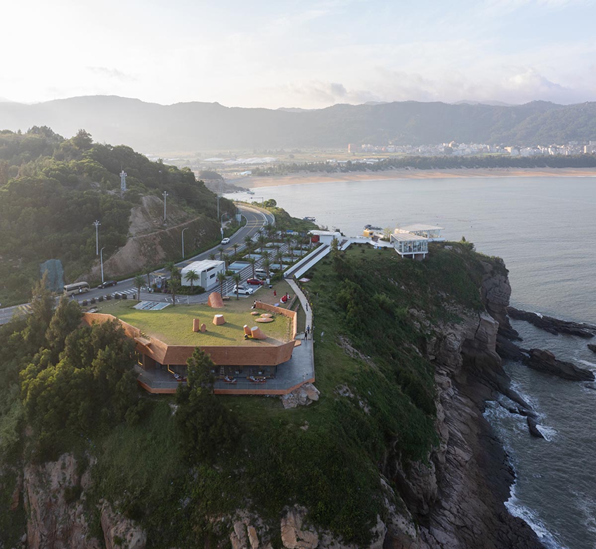 A gallery on a cliff has irregularly shaped lighting pipes that imitate creatures in China Marine