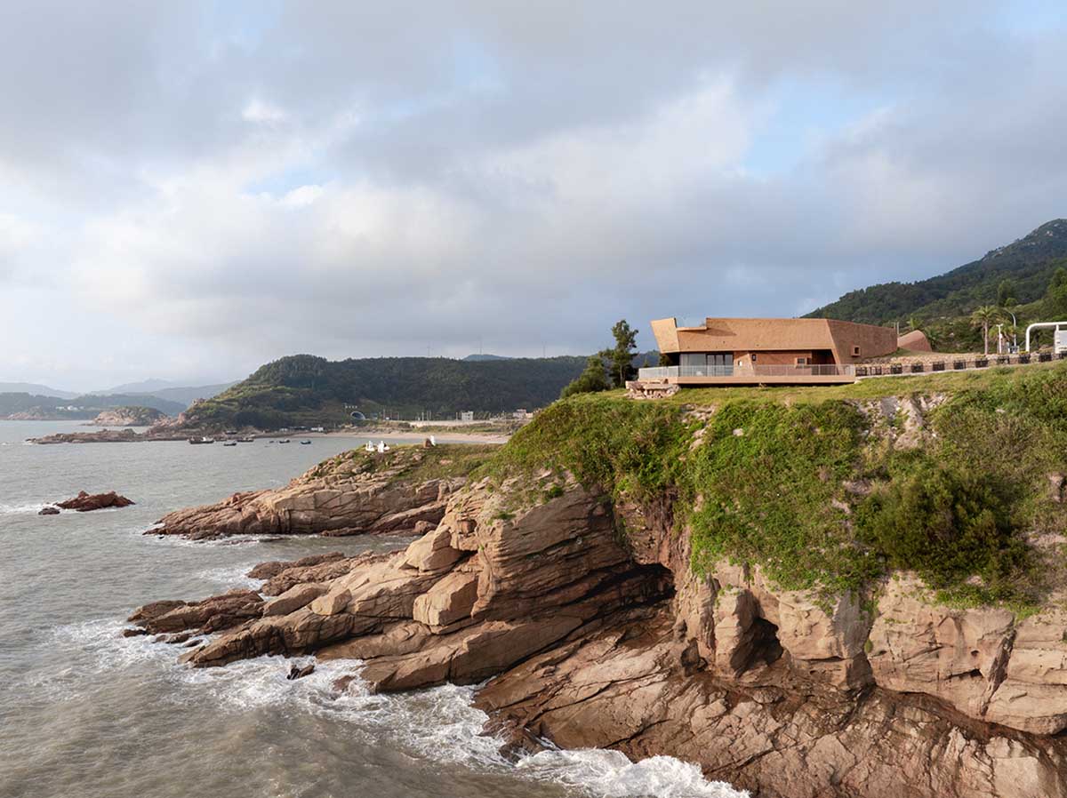 A gallery on a cliff has irregularly shaped lighting pipes that imitate creatures in China Marine