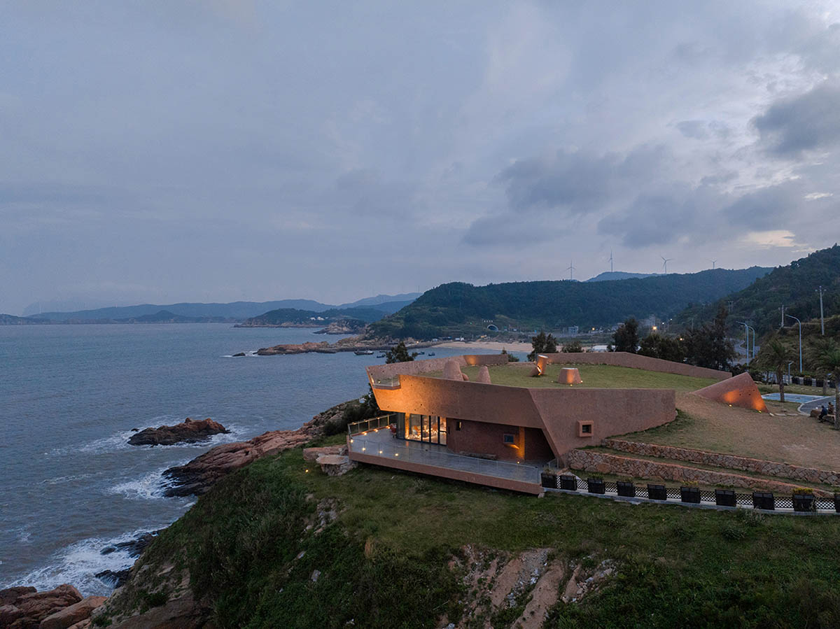 A gallery on a cliff has irregularly shaped lighting pipes that imitate creatures in China Marine