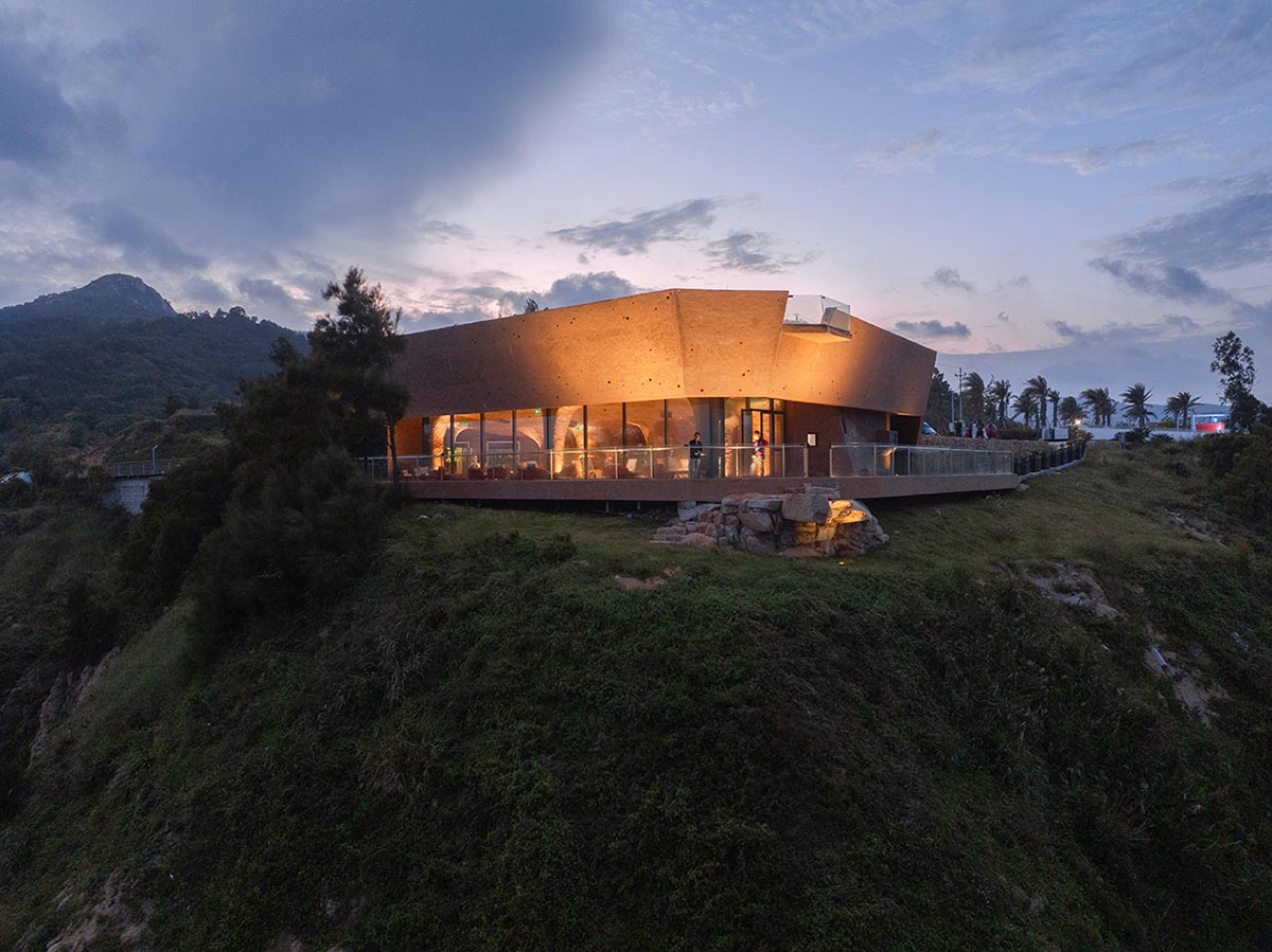 A gallery on a cliff has irregularly shaped lighting pipes that imitate creatures in China Marine