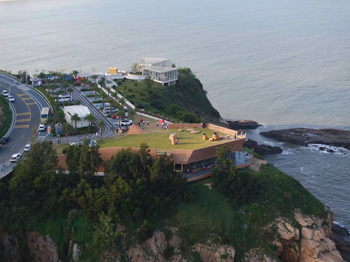 A gallery on a cliff has irregularly shaped lighting pipes that imitate creatures in China Marine