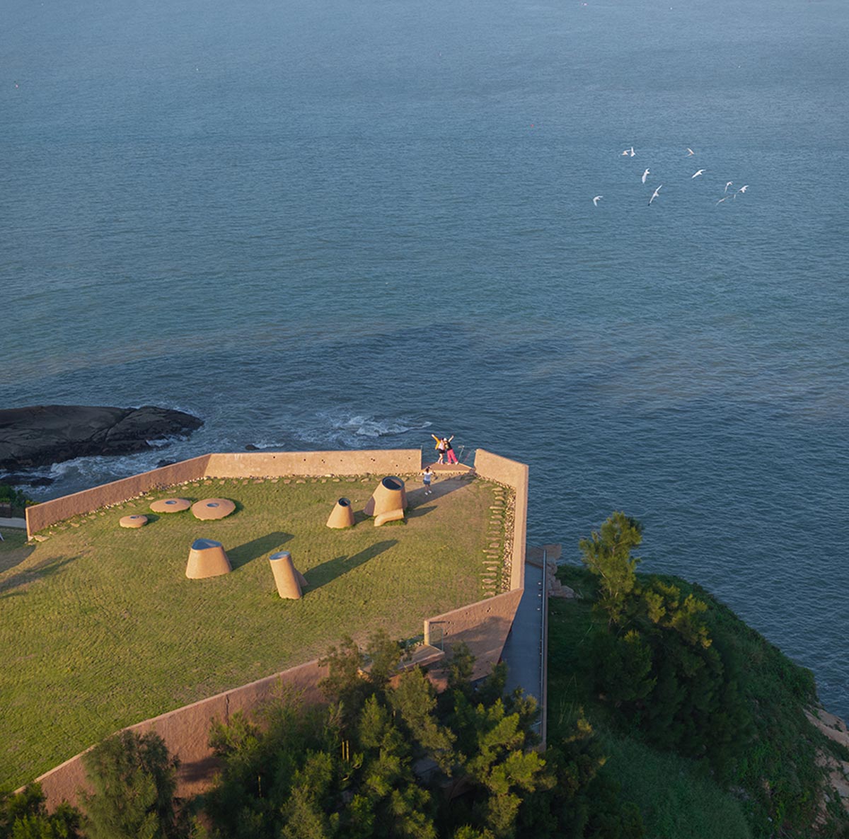 A gallery on a cliff has irregularly shaped lighting pipes that imitate creatures in China Marine