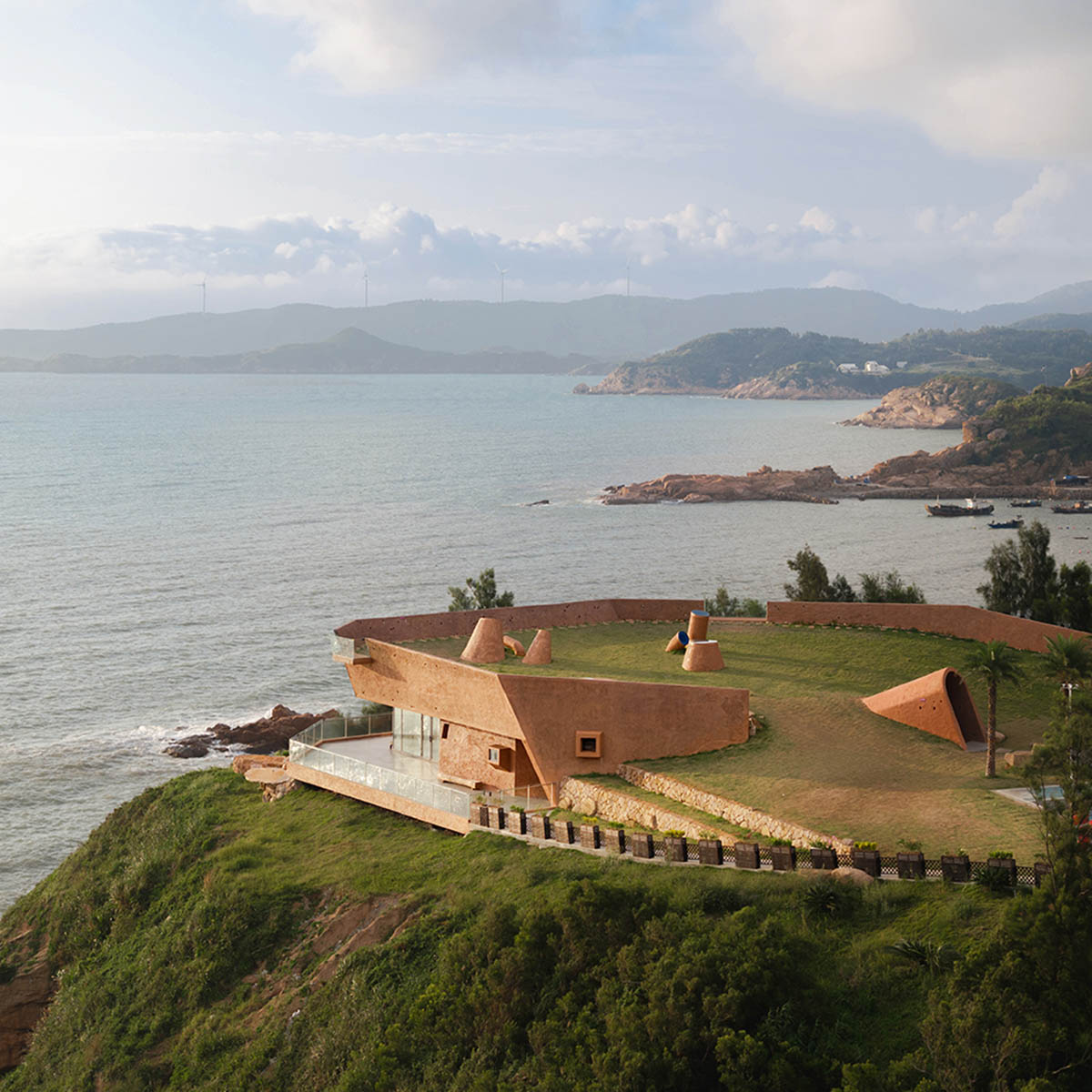 A gallery on a cliff has irregularly shaped lighting pipes that imitate creatures in China Marine