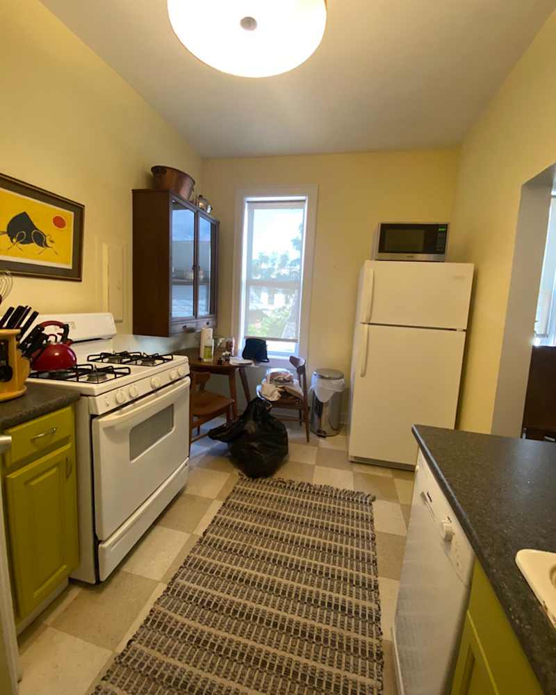 Small, green kitchen renovated and converted into burgundy -colored and red kitchen with chess board floor.