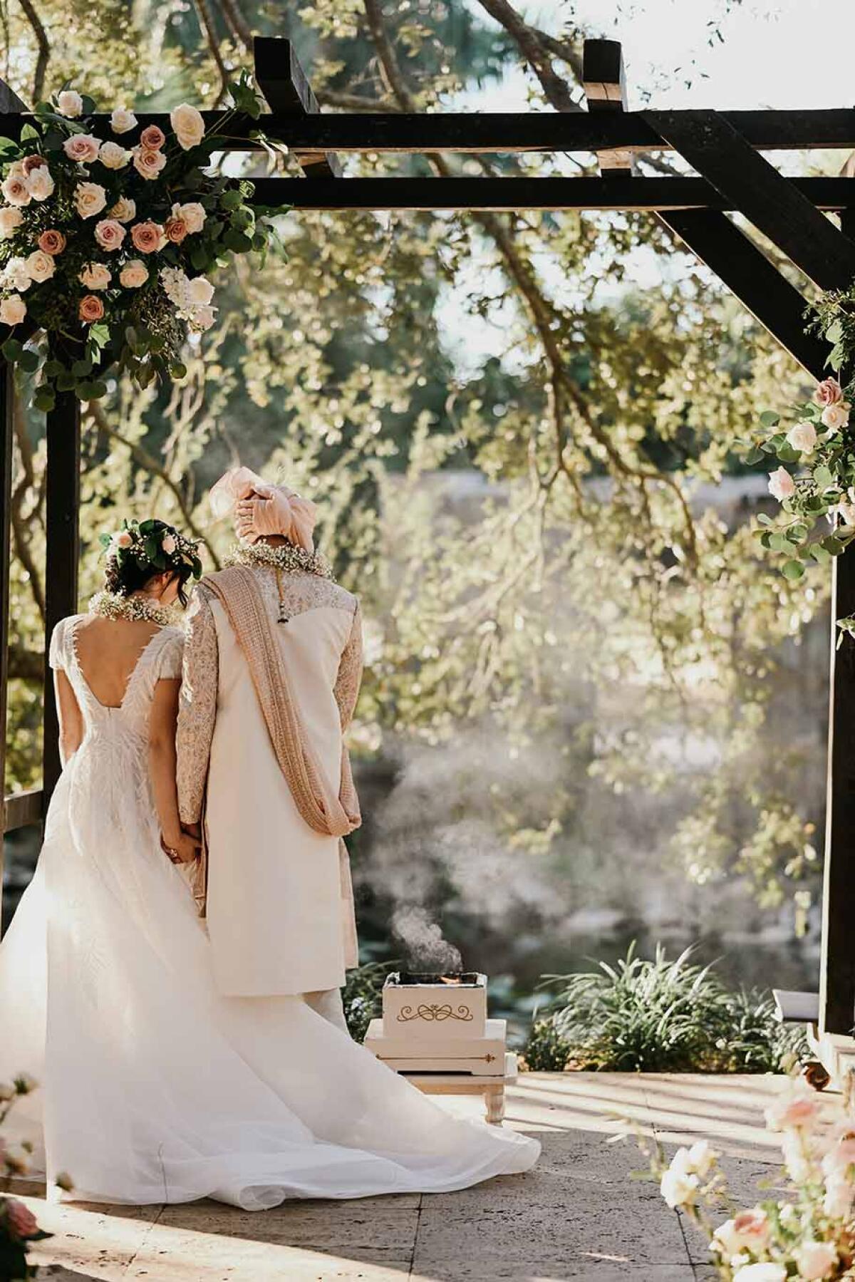 A couple shares a ritual as part of their wedding ceremony in the Living Sculpture Sanctuary.