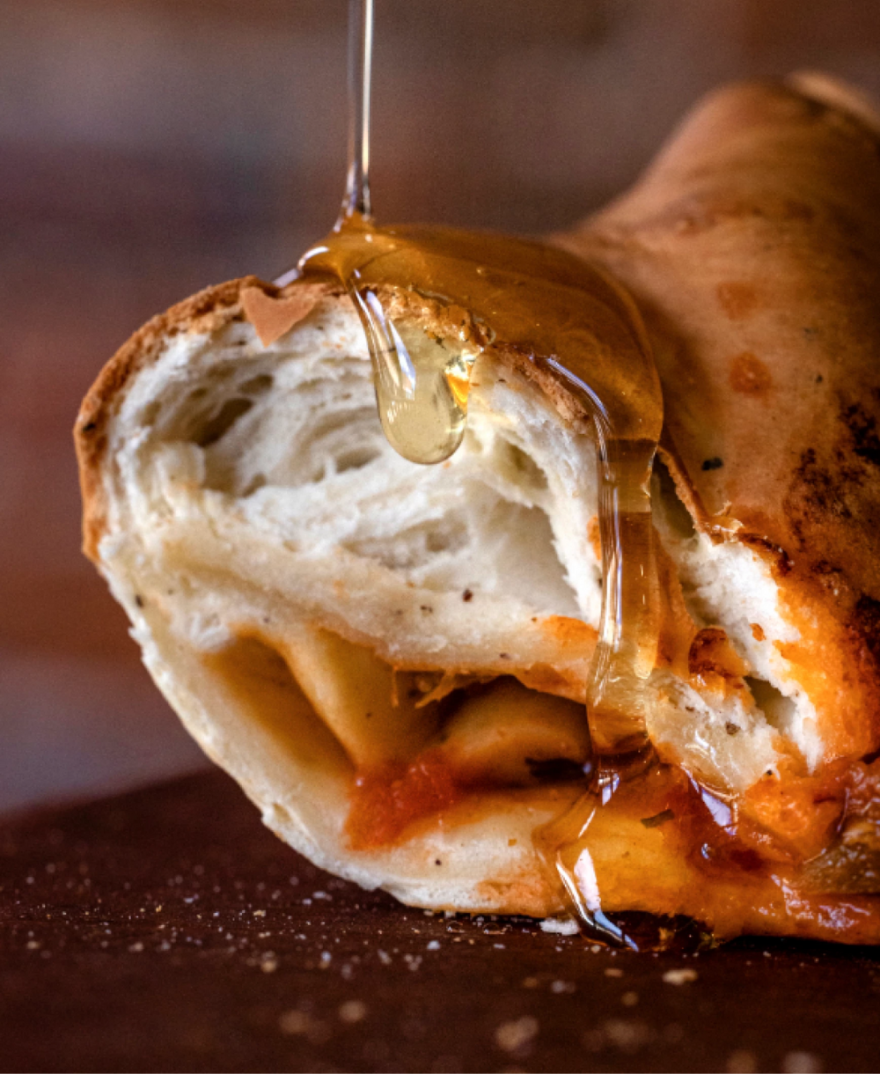 A pizza crust with honignie from above