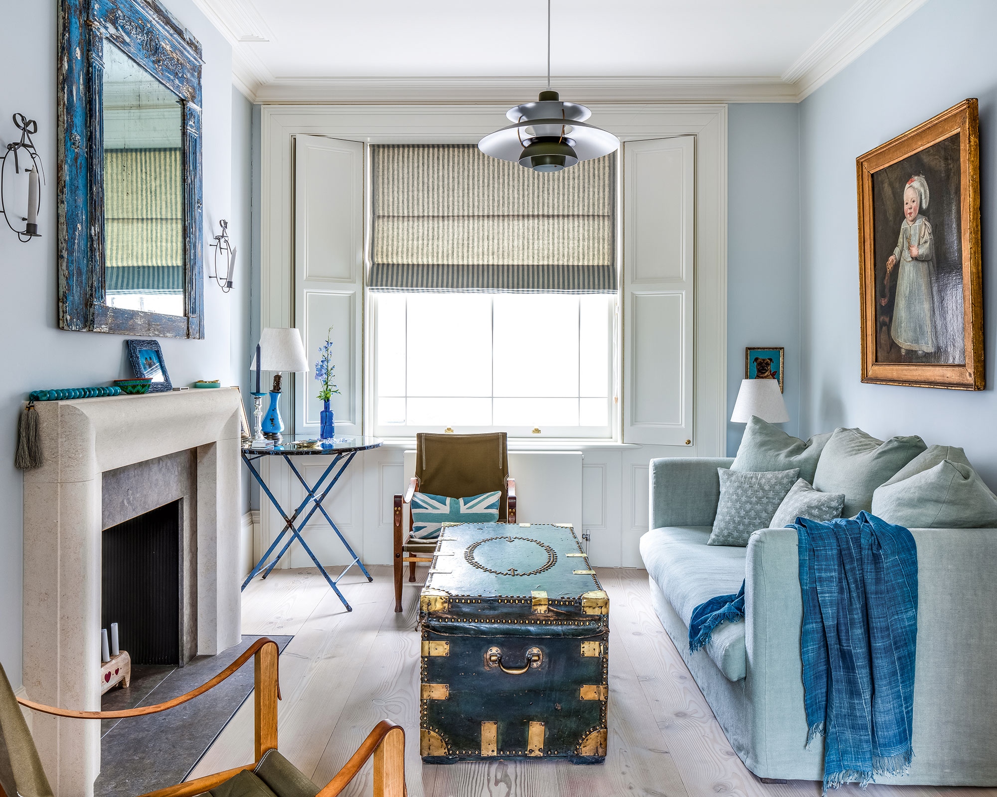 Blue living room with a blue sofa, coffee table and converted