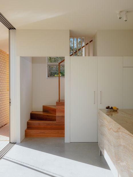 The inner staircase is located behind the front facade and acts as a visual buffer between the street and the frequently occupied areas of the house.
