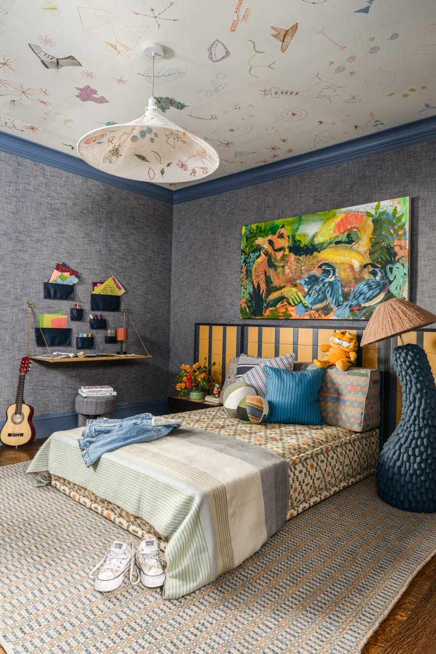 A colorful and playful children's room with a bed decor and artistic elements A colorful and playful children's room with a bed decor and artistic elements