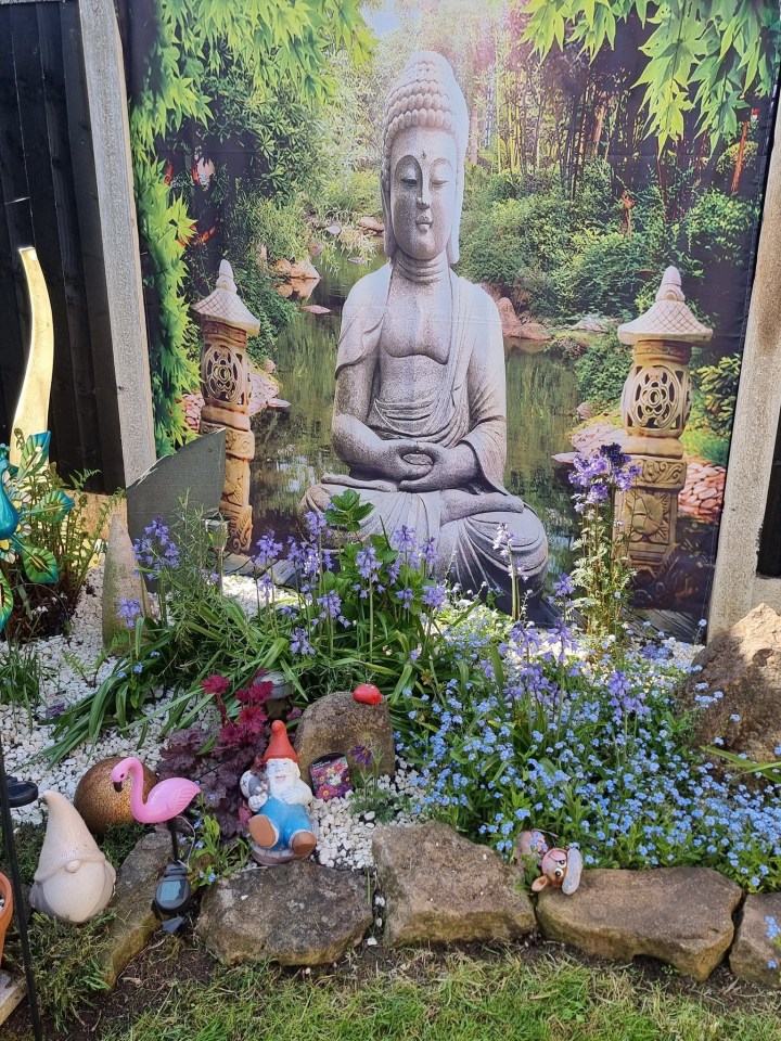 Garden with a Buddha statue -backdrop and garden nerves.