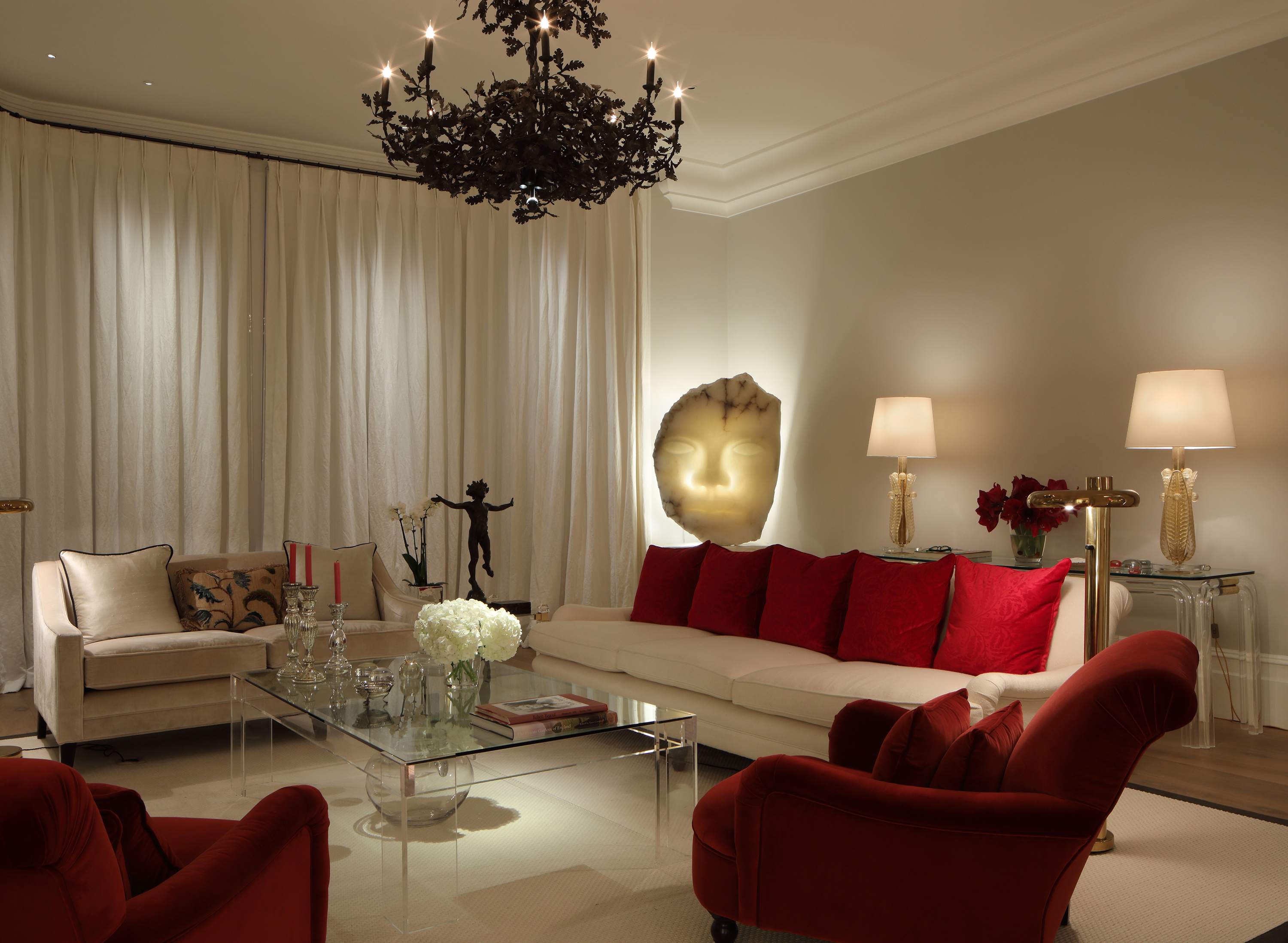 Skulpture backlit from John Cullen lighting in a cream -colored and red colored living room