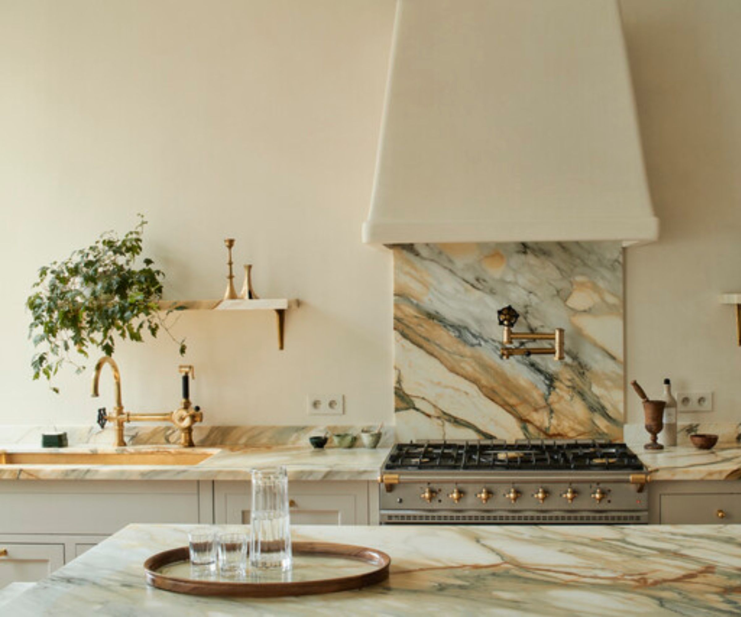 A warm white kitchen with heavily sanded stone slabs