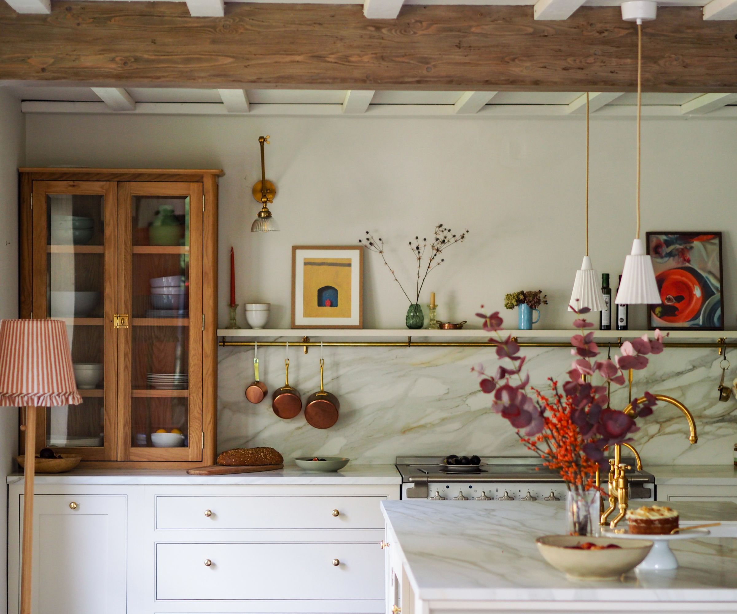 A land kitchen with white and wooden cabinets