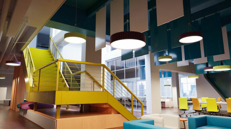 Modern office interior with yellow staircase, hanging ceiling panels, round lights and colorful chairs and sofas. Large windows offer cityscapes.
