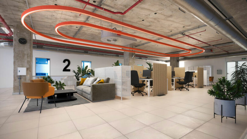 Modern open plan office with exposed ceilings, orange accent lighting, partitions, green, sofa, armchairs, desks and a large number 2 on the wall.