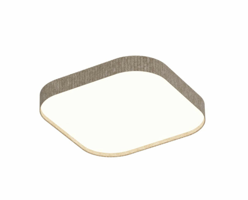 A square leaf light material with rounded corners, limited by a thin, upright, structured strip.