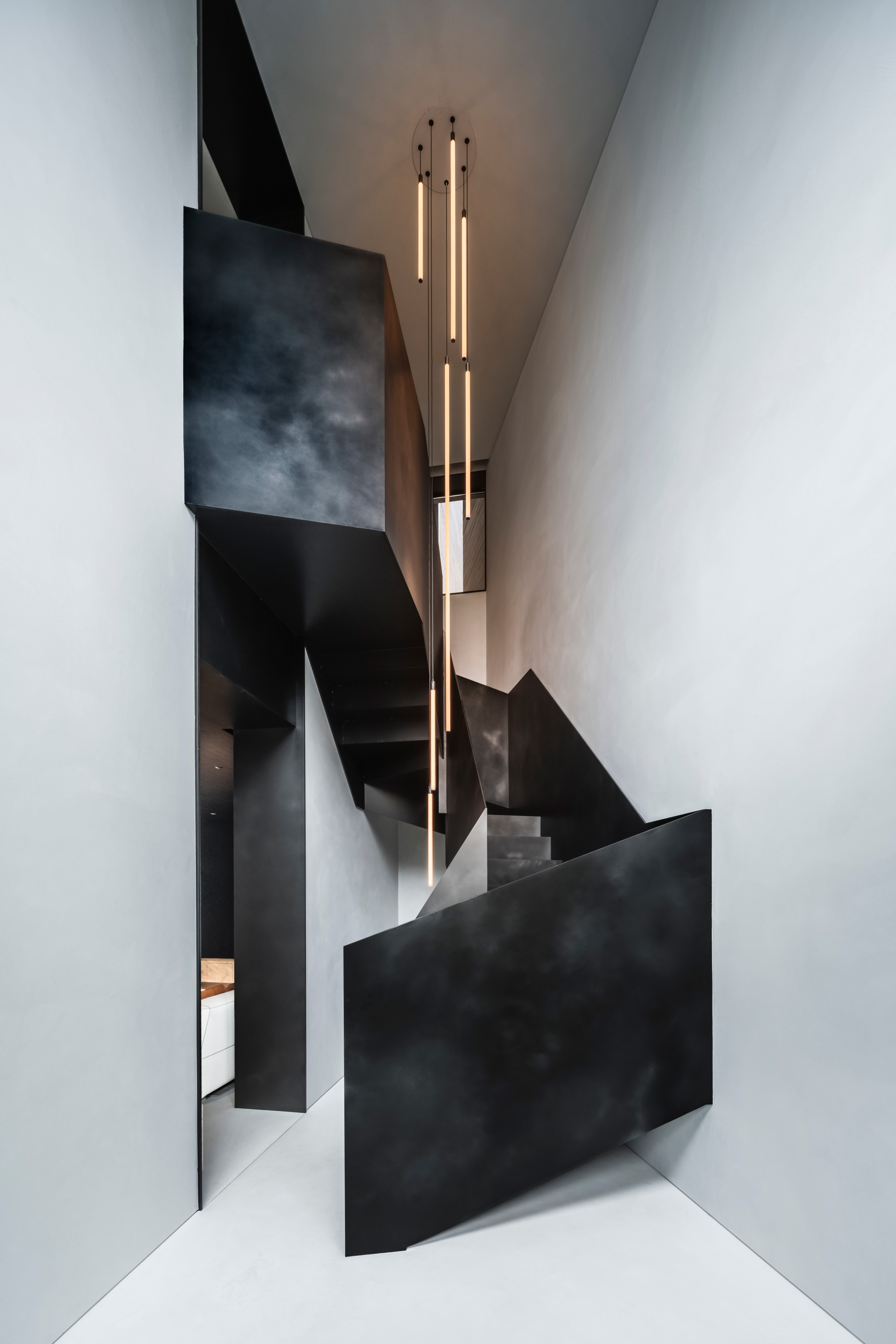 The folded steel staircase is a sculptural heart of the town house