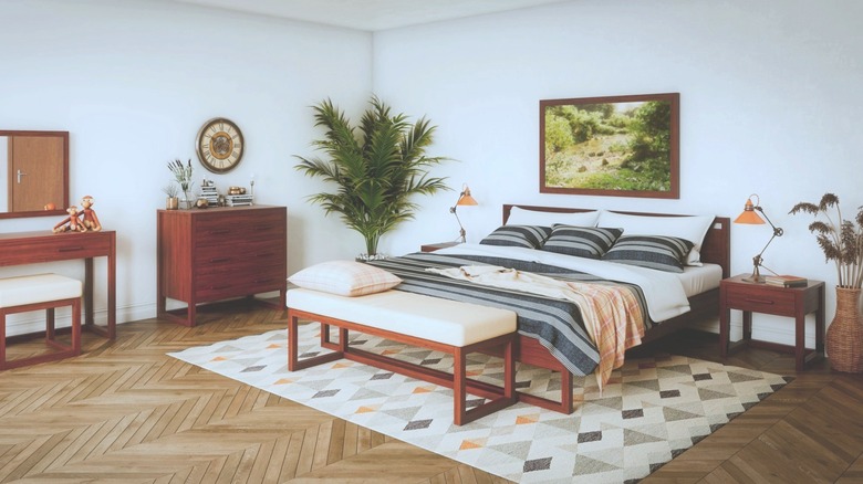 A spacious bedroom has an orange oak bed set.