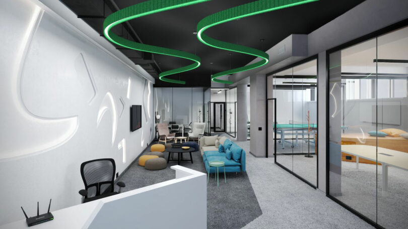 Modern office space with glass rooms with glass, lounge seating, a table in the pong and a green LED ceiling lights.