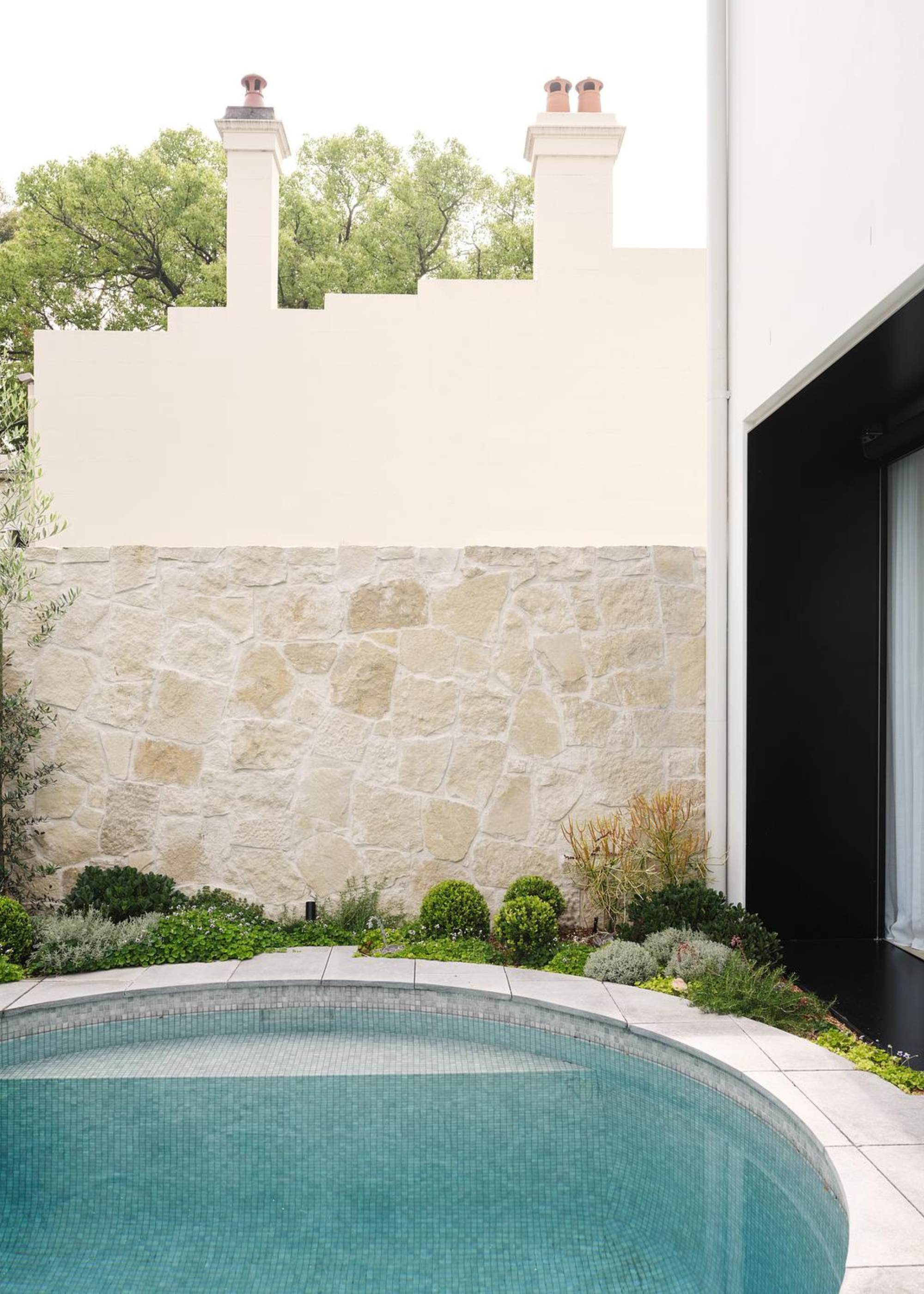 A small circular diving pool in a garden garden
