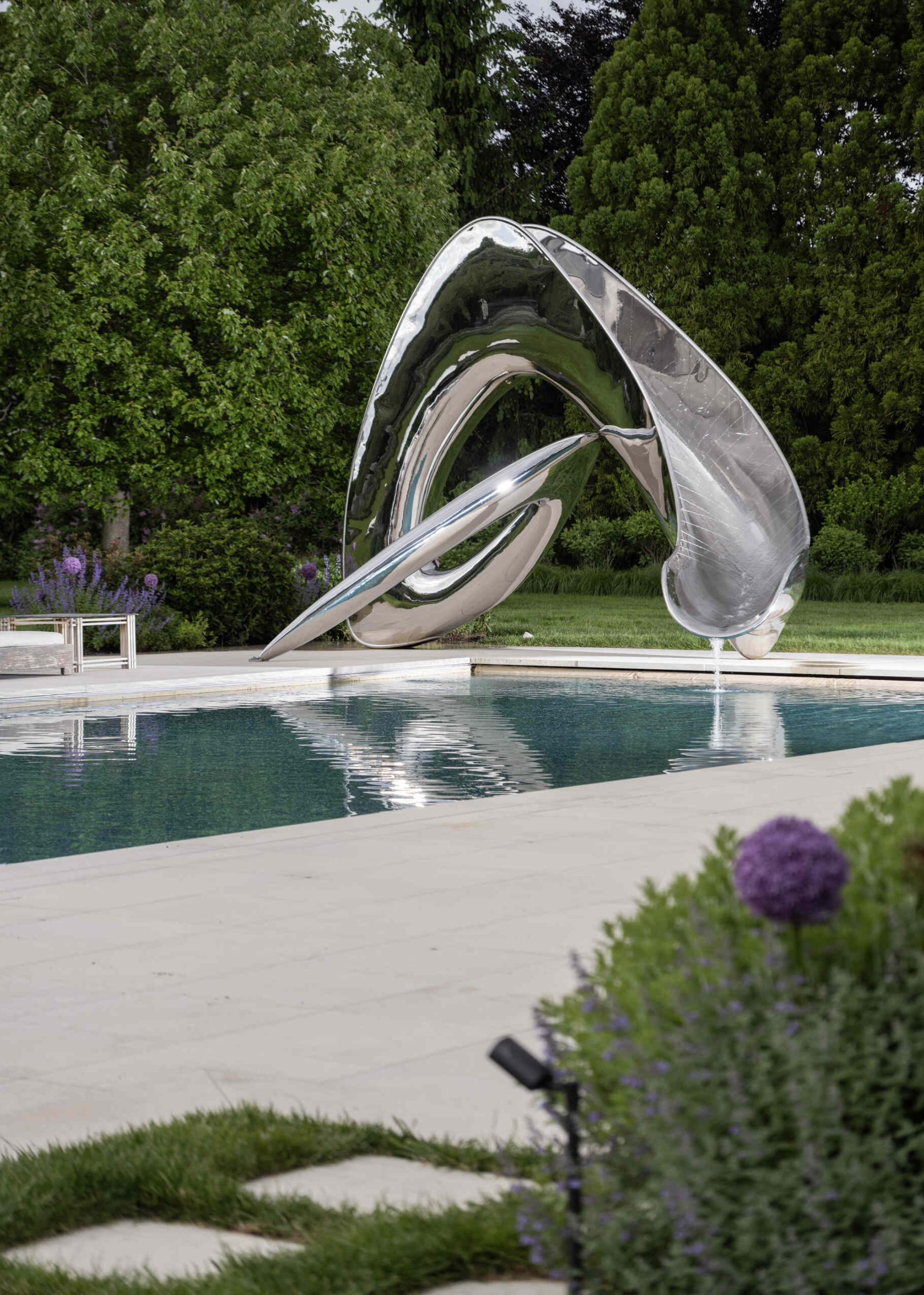 Spinterworks chrome stainless steel sculptural film in an outer pool